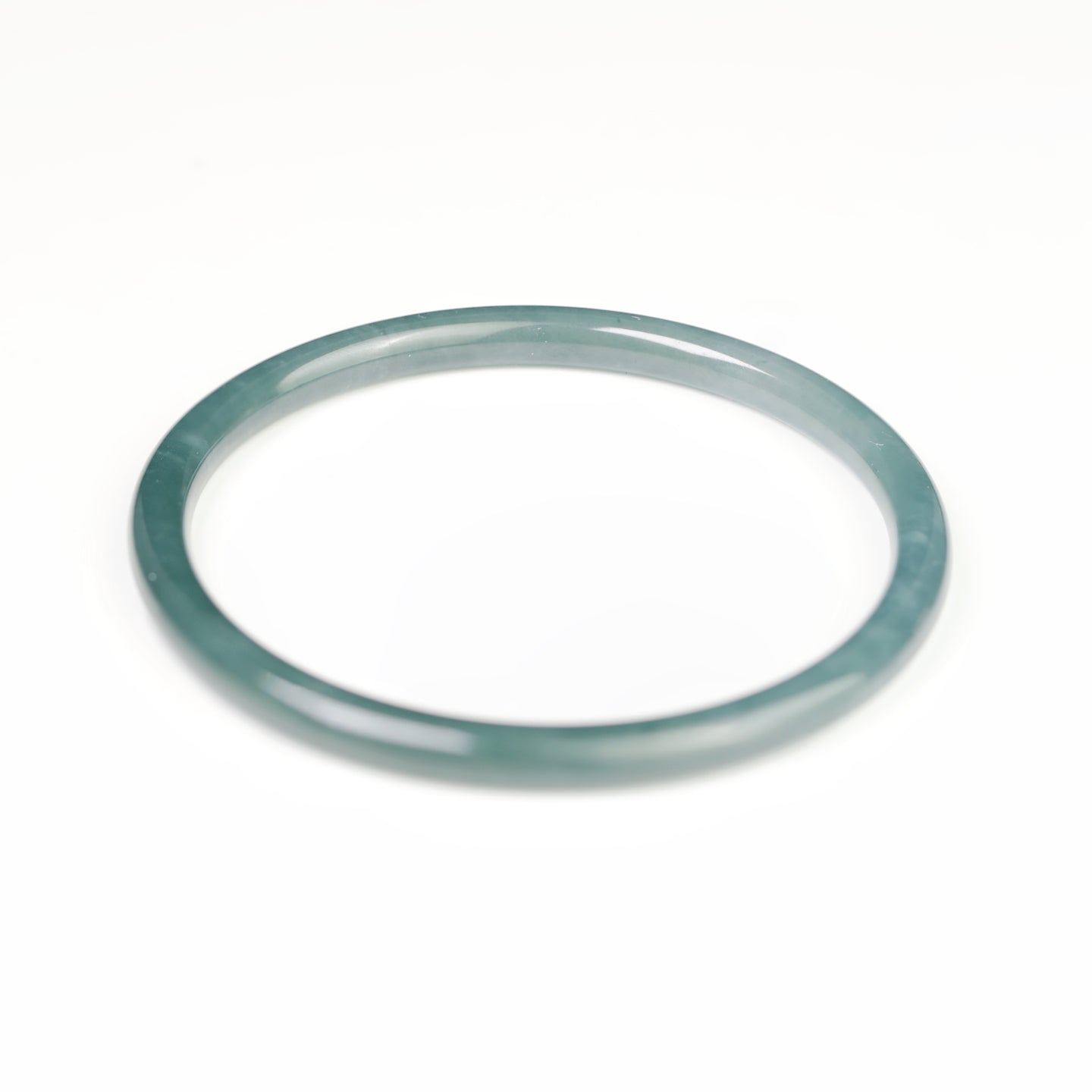 Blue-water round-profile jadeite bangle, size 60mm.